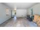 Spacious garage interior with concrete floor, white painted walls, and natural light from windows and exterior door at 219 Stribling Dr, Auburndale, FL 33823