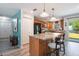 Open kitchen with granite countertops, black appliances, and island with breakfast bar seating at 219 Stribling Dr, Auburndale, FL 33823