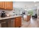 Open-concept kitchen featuring stainless steel appliances, granite countertops, and seamless flow to the living area at 219 Stribling Dr, Auburndale, FL 33823