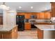 Spacious kitchen with wood cabinets, granite countertops, stainless appliances, and luxury vinyl floors at 219 Stribling Dr, Auburndale, FL 33823