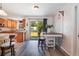 Bright kitchen and breakfast nook with island, bar seating, stainless appliances, and backyard access at 219 Stribling Dr, Auburndale, FL 33823