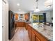 Bright kitchen with wood cabinets, granite countertops, stainless steel appliances, and a center island with bar seating at 219 Stribling Dr, Auburndale, FL 33823