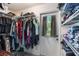 Walk-in closet with an exterior door featuring clothes racks, shelves, and wood-look floors at 219 Stribling Dr, Auburndale, FL 33823