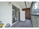 Enclosed balcony with exterior door and sliding glass doors, offering an outdoor living space at 2329 Oak Park Way # 204, Orlando, FL 32822