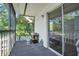 Balcony with black metal railing and sliding glass doors, with view of mature trees at 2329 Oak Park Way # 204, Orlando, FL 32822