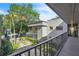 Balcony with neighborhood view, featuring mature trees and landscaping at 2329 Oak Park Way # 204, Orlando, FL 32822