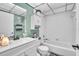 Well-lit bathroom features a sleek vanity, toilet, and a clean, white tiled shower-tub combo at 2329 Oak Park Way # 204, Orlando, FL 32822