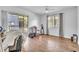 Spacious bedroom with a sliding glass door to a balcony, a ceiling fan, and wood-look flooring at 2329 Oak Park Way # 204, Orlando, FL 32822