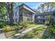 Attractive condo exterior with a screened patio in a lush landscaped setting at 2329 Oak Park Way # 204, Orlando, FL 32822