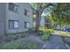 Attractive apartment building with manicured landscaping and mature trees providing shade at 2329 Oak Park Way # 204, Orlando, FL 32822