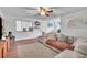 Bright living room featuring stylish furnishings, a ceiling fan, and modern decor at 2329 Oak Park Way # 204, Orlando, FL 32822