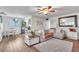 Bright living room featuring stylish furnishings, a ceiling fan, and modern decor at 2329 Oak Park Way # 204, Orlando, FL 32822
