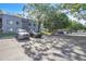 Wide parking lot area in front of condo building and lots of shaded parking spaces at 2329 Oak Park Way # 204, Orlando, FL 32822