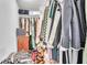 Spacious walk-in closet provides ample storage with hanging racks and shelves for organized living at 2329 Oak Park Way # 204, Orlando, FL 32822