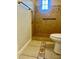 The bathroom is tiled and features a shower and toilet at 235 Crabtree Ave, Orlando, FL 32835