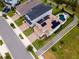 Aerial view of home with solar panels, manicured lawns, and a backyard pool with an entertaining area at 2683 Bobcat Chase Blvd, Oakland, FL 34787