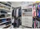 Walk-in closet features ample storage with built-in shelves, drawers, and hanging rods at 2683 Bobcat Chase Blvd, Oakland, FL 34787