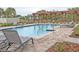 A community pool featuring lounge chairs, picnic tables, and a wooden pergola at 2683 Bobcat Chase Blvd, Oakland, FL 34787