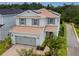 Two-story home featuring solar panels, a two-car garage, and well-maintained landscaping at 2683 Bobcat Chase Blvd, Oakland, FL 34787