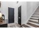 Bright foyer featuring a staircase and dark wood entry doors at 2683 Bobcat Chase Blvd, Oakland, FL 34787