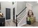 Inviting foyer area with staircase and black entry doors at 2683 Bobcat Chase Blvd, Oakland, FL 34787