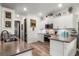 Modern kitchen with white cabinetry, stainless steel appliances, and a subway tile backsplash for a sleek and functional design at 2683 Bobcat Chase Blvd, Oakland, FL 34787
