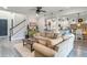 Cozy living area open to the kitchen featuring a sectional couch and brick accent wall at 2683 Bobcat Chase Blvd, Oakland, FL 34787