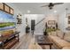 Cozy living room with rustic decor, a large television, wood floors, and a decorative brick wall at 2683 Bobcat Chase Blvd, Oakland, FL 34787