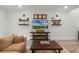Cozy living room features stylish decor, floating shelves, and a rustic wooden coffee table for a warm and inviting space at 2683 Bobcat Chase Blvd, Oakland, FL 34787