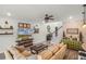 Inviting living room featuring a comfortable sofa, rustic decor, and a brick accent wall at 2683 Bobcat Chase Blvd, Oakland, FL 34787