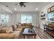Spacious living room with large sectional sofa, rustic coffee table, and sliding doors for indoor-outdoor living at 2683 Bobcat Chase Blvd, Oakland, FL 34787