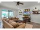 Inviting living room featuring a large sectional, rustic coffee table, and decorative shelving for a comfortable and stylish space at 2683 Bobcat Chase Blvd, Oakland, FL 34787