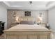 Bright main bedroom with a decorative brick accent wall, nightstands and a ceiling fan at 2683 Bobcat Chase Blvd, Oakland, FL 34787