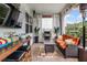 Relaxing outdoor patio with comfortable seating, a tv and a grill at 2683 Bobcat Chase Blvd, Oakland, FL 34787
