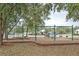 A community playground with swings and climbing equipment surrounded by trees at 2683 Bobcat Chase Blvd, Oakland, FL 34787