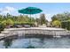 Beautiful backyard pool with rock accents, lounge seating, and lush privacy landscaping at 2683 Bobcat Chase Blvd, Oakland, FL 34787