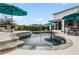 Backyard pool with built in fountains surrounded by lounge seating, umbrellas, and lush landscaping at 2683 Bobcat Chase Blvd, Oakland, FL 34787