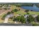 Aerial view of a beautiful home, golf course, and lake in a well-manicured community at 2780 Highland View Cir, Clermont, FL 34711