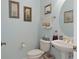 Powder room featuring a pedestal sink, decorative mirror, and neutral wall color at 2780 Highland View Cir, Clermont, FL 34711