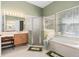 Bathroom features tile flooring, shower, soaking tub, vanity, and large window at 2780 Highland View Cir, Clermont, FL 34711