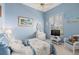 Bedroom with blue walls, ceiling fan, and window to let in plenty of natural light at 2780 Highland View Cir, Clermont, FL 34711