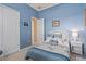Bedroom with blue walls, closet, and a window to let in plenty of natural light at 2780 Highland View Cir, Clermont, FL 34711