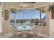 Breakfast nook with a glass table setting and a lovely view of the pool and waterway at 2780 Highland View Cir, Clermont, FL 34711