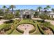Picturesque clubhouse entrance framed by manicured landscaping and vibrant flags at 2780 Highland View Cir, Clermont, FL 34711