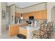 Bright kitchen features wooden cabinets, stainless steel appliances, and a breakfast bar at 2780 Highland View Cir, Clermont, FL 34711