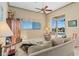 Comfortable living room with a plush sofa, reclining chair, and pool views at 2780 Highland View Cir, Clermont, FL 34711