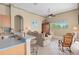 View of kitchen with barstool seating and living room with a rocking chair at 2780 Highland View Cir, Clermont, FL 34711