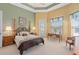 Comfortable main bedroom features large windows and access to the backyard at 2780 Highland View Cir, Clermont, FL 34711
