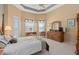 Spacious main bedroom features tray ceiling, walk-out to patio, and en-suite bathroom at 2780 Highland View Cir, Clermont, FL 34711