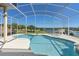 Sparkling in-ground pool and spa with screened-in enclosure offers stunning lake and landscape views at 2780 Highland View Cir, Clermont, FL 34711